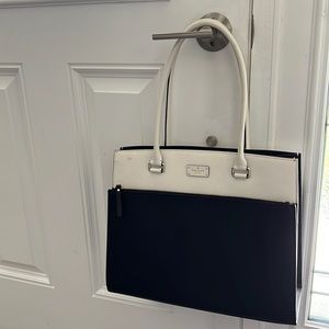 Kate Spade tote. Black and white. Front zipper pocket. Shoulder straps. Used
